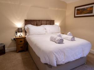 a bedroom with a large white bed with two pillows at 3 Bed in Buttermere 82775 in Buttermere