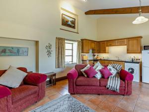 a living room with two couches and a kitchen at 1 Bed in South Molton LAKVI in South Molton