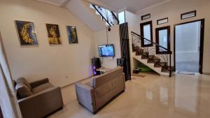 a living room with a couch and a tv at Villa Estate 43 New in Batu