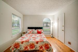 a bedroom with a bed and two windows at 3 Mi to Downtown Dallas Condo with Pool Access! in Dallas +17 photos