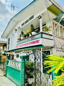 a house with a balcony with potted plants on it at SMITH'S HOMESTAY in Georgetown