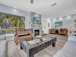 a living room with a piano and a fireplace at 5 Minute Walk to the Beach in Fort Lauderdale