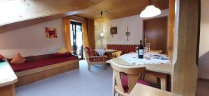 a living room with a table and a dining room at Haus Rosi Trenkle in Pfronten