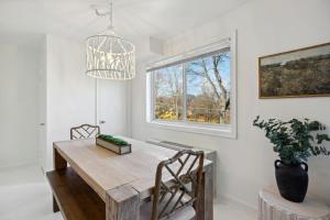 a dining room with a wooden table and a window at Crystal City Boutique Flats 2BR - Free Parking 204 in Arlington