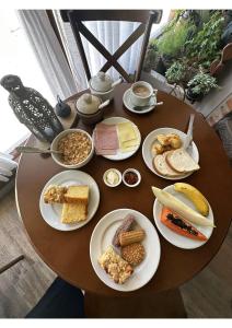 a table with plates of food on top of it at Hotel Imigrantes in Bento Gonçalves