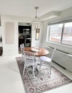 a dining room with a table and four chairs at Crystal City Boutique Flats Free Parking 201 in Arlington
