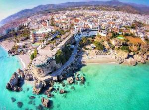 an aerial view of a resort on a beach at Naim Guest House Nerja in Nerja