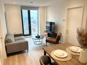 a living room with a couch and a table at 2bedroom luxury apartment city centre V in Manchester