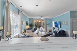 a living room with blue walls and a table and chairs at Arbor Trace #811 condo in North Myrtle Beach