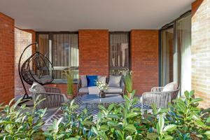 a patio with two chairs and a table with flowers at Gdańsk Old Town Scala Premium Apartments D with Parking by Lion Apartments in Gdańsk