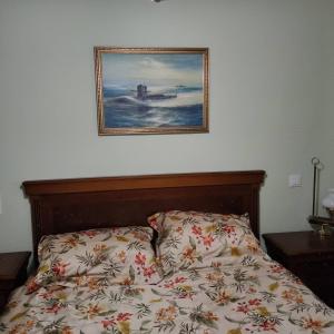 a bedroom with a bed with a picture on the wall at Apartments in a "VILLA VISTA JAVEA" in Jávea