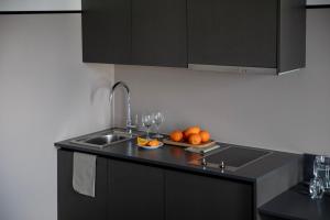 a kitchen with a sink and a plate of fruit at Bob W Copenhagen Østerbro in Copenhagen