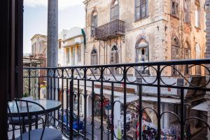 a balcony with a table and some buildings at My Luxury Downtown Vibe Suites in Rethymno