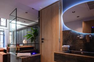 a room with a large mirror and a room with a couch at My Luxury Downtown Vibe Suites in Rethymno +50 photos