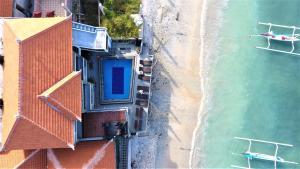 an aerial view of a building and the ocean at Pradana Beach Inn Luxury in Nusa Penida