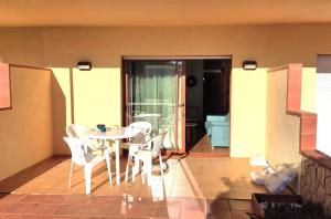 a patio with a table and chairs on a balcony at Apartamento en primera linea de mar en Pals 306-1 2H in Pals
