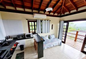 a kitchen and living room with a bed and a sink at Burung Flats Itamambuca - Hospedagem com vista para o mar in Ubatuba