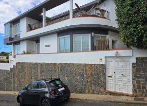 een zwarte auto geparkeerd voor een huis bij Apartamento Drago in Santa Cruz de Tenerife