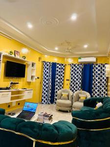 a living room with two couches and a tv at Villa meublée climatisé en cours unique in Ouagadougou