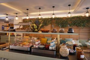 a buffet in a restaurant with food on a counter at Hôtel Des Mines in Paris