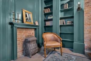 a chair in a room with a brick fireplace at The Historic Grand Canyon Hotel in Williams