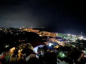 a view of a city at night with lights at Grand Sri Lounge - Ocean Breeze Hotel residents in Negombo