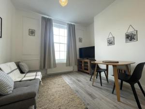 a living room with a couch and a table at Apartment 2 St Georges in Cheltenham