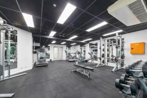 a gym with several treadmills and machines at Lux Sub-Penthouse with Casino views in Brisbane
