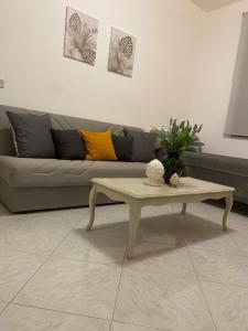 a living room with a couch and a coffee table at Montalbano House - Casa Vacanze in Santa Margherita di Belice