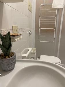 a bathroom with a white sink and a toilet at Montalbano House - Casa Vacanze in Santa Margherita di Belice