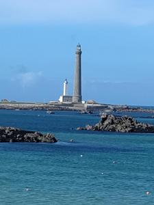 a lighthouse on an island in the water at chambre d hôtes au pays des abers in Lannilis