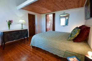 a bedroom with a bed and a table with a lamp at Duca House in San Giovanni