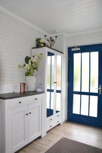 un armadietto bianco con porta blu in una stanza di Ferienwohnungen Ansbach - Ansbach Apartments - Your home away from home! ad Ansbach