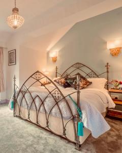a bedroom with a bed with a metal frame at Lilac Cottage Morpeth Northumberland in Morpeth