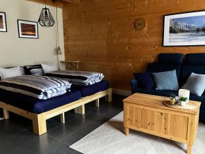 a living room with two beds and a couch at Chalet Alpina Gyger in Wengen