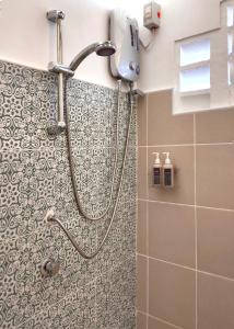 a shower in a bathroom with a tile wall at Las Terrazas de Barili in Barili