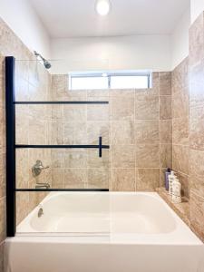 a white bath tub in a bathroom with a window at Cozy Guesthouse in LA (WO2 - BUR) in Burbank