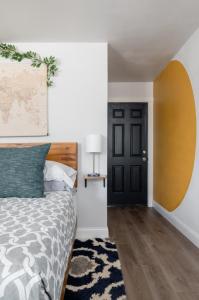 a bedroom with a bed and a black door at Schoaf Cottage at Wrenwood Ranch in Johnson City