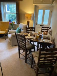 a living room with a table with food on it at Peaceful cottage Peak District, nr Bakewell in Buxton