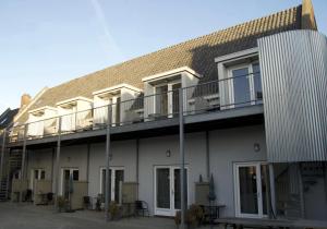 - un balcon avec des tables et des chaises dans l'établissement Woonhotel Petruskerk, à Flessingue