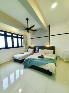 a bedroom with two beds and a ceiling fan at 3703 Meridin Sovo 6paxCozy Legoland Netflix BySTAY in Nusajaya +50 photos
