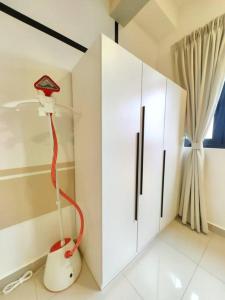 a room with a white cabinet and a red vacuum at 3703 Meridin Sovo 6paxCozy Legoland Netflix BySTAY in Nusajaya