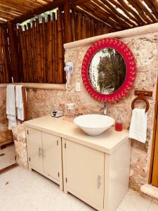 a bathroom with a sink and a mirror at Casa Quetzal Hotel in Valladolid