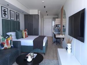 a bedroom with a bed and a desk in a room at Executive Apartment at Ellipse Waterfall in Midrand