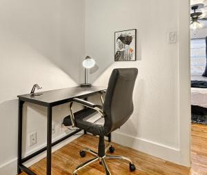 a black desk with a chair and a lamp at CityPlace bnb Aparthotel in Dallas