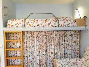 a bedroom with a bunk bed with a canopy at La Quiniela in Aviá