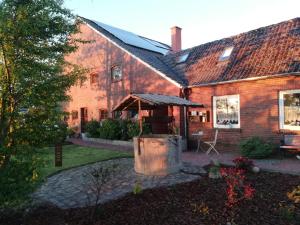a brick house with a grill in the yard at Ferienhaus Bonishof in Westerholt +65 photos