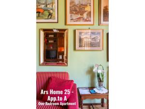 a living room with a red couch and pictures on the wall at Ars Home - Santa Maria Novella - Ezia Home & Ars Home 25 in Florence