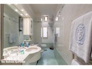 a bathroom with a sink and a tub and a toilet at Ars Home - Santa Maria Novella - Ezia Home & Ars Home 25 in Florence