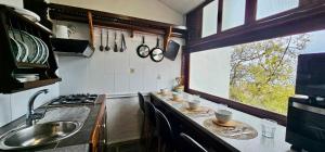 a kitchen with a sink and a counter with cups and dishes at Cuevita Bimbache in Valverde